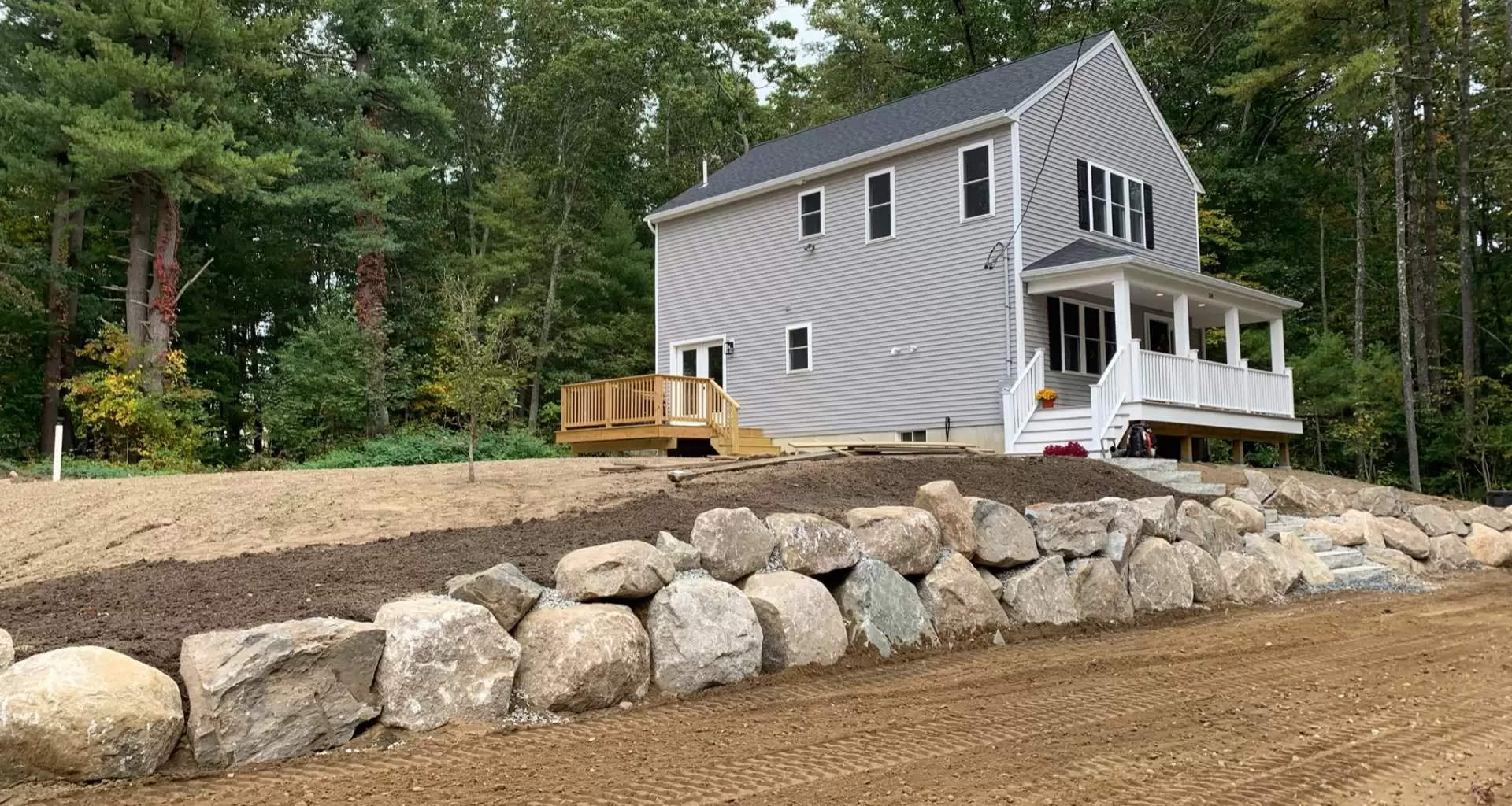 Photo of landscaping project view of house with stone staircase